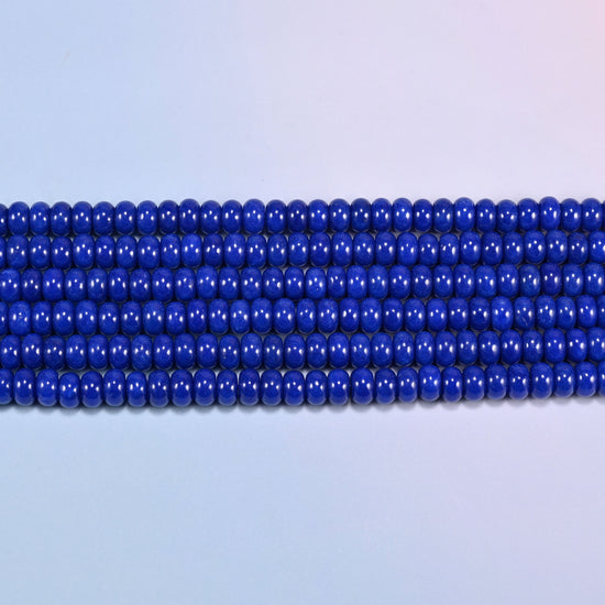 Dark Blue dyed jade gemstone rondelle beads in straight rows, showing the flat 5x8mm disc profile and centre drilling