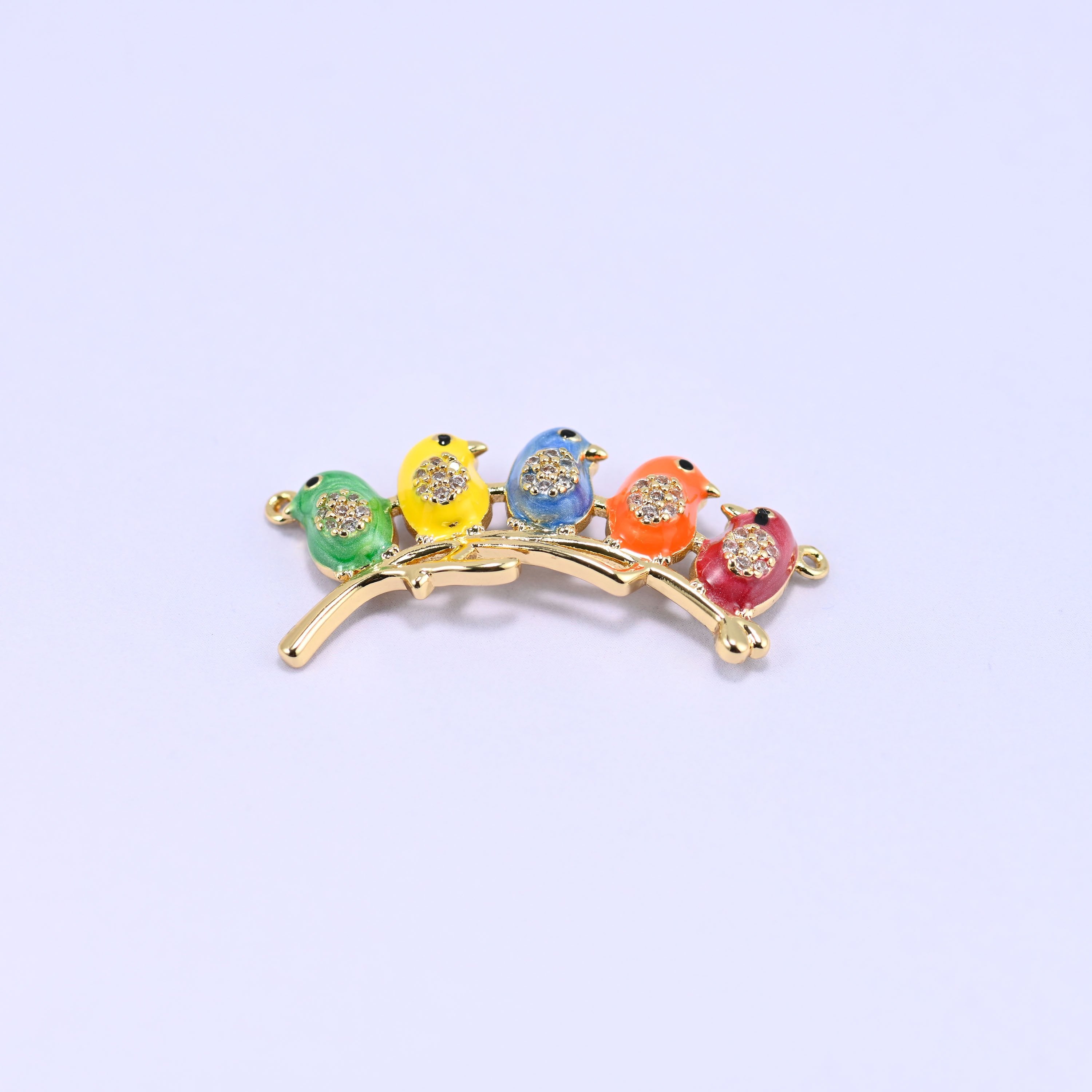 Five enamel birds lined up along a curved gold branch connector