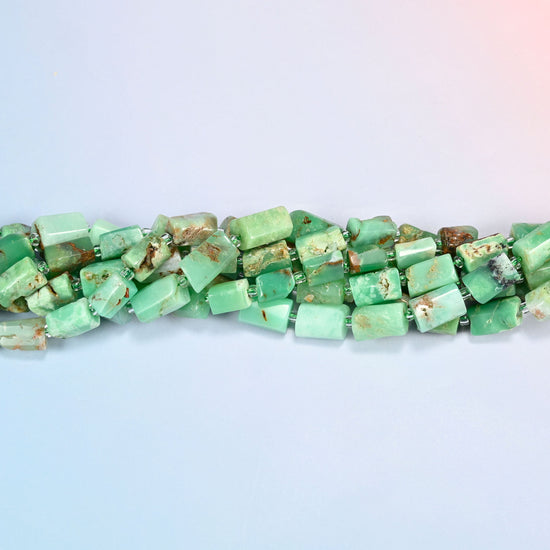 Strands of Australian jade faceted tube beads twisted together in a horizontal row