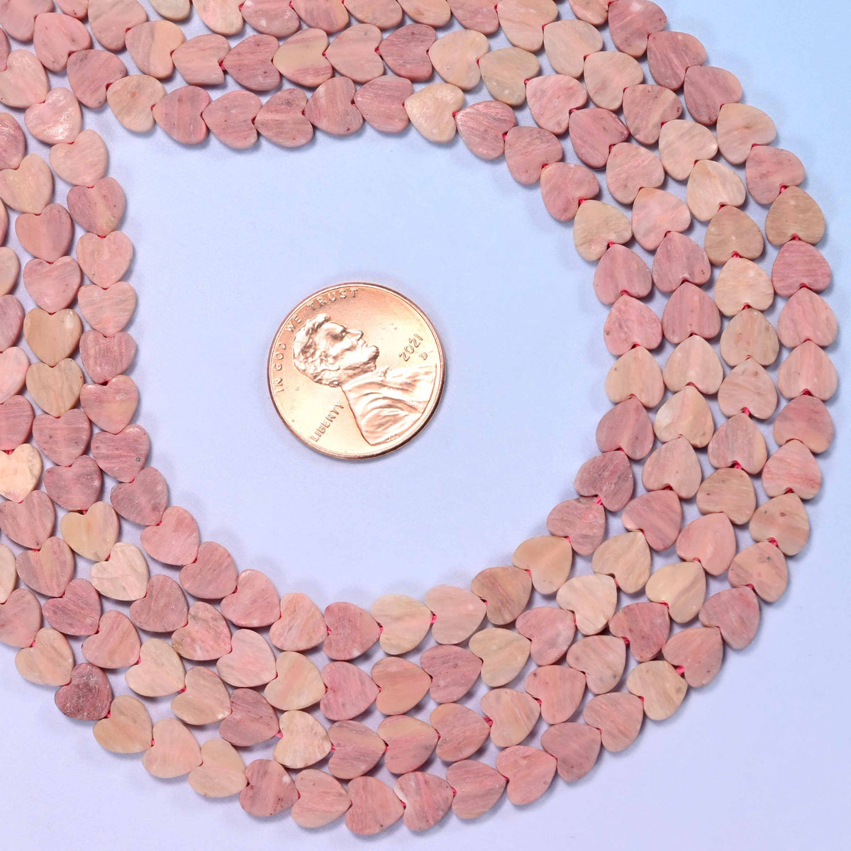 Matte pink rhodonite flat heart beads, approximately 68 per strand