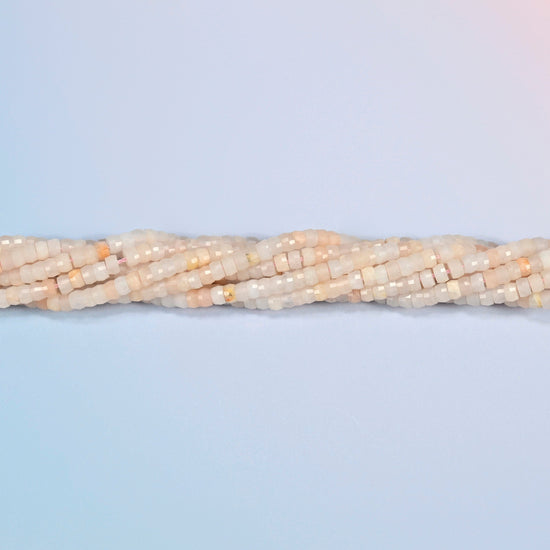 Strands of pink aventurine faceted heishi disc beads twisted together in a horizontal row