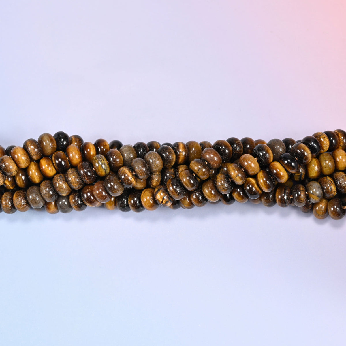 Natural Tiger's Eye rondelle beads in rich golden brown and deep chocolate tones with a chatoyant shine.