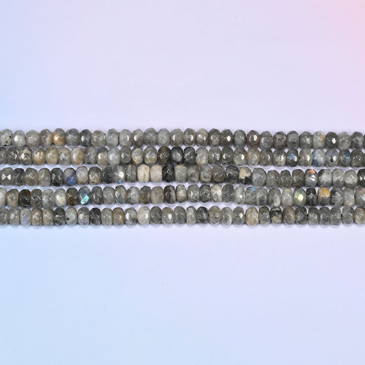 Gray Labradorite faceted rondelle beads in horizontal rows, the flat disc shape sitting close along the strand