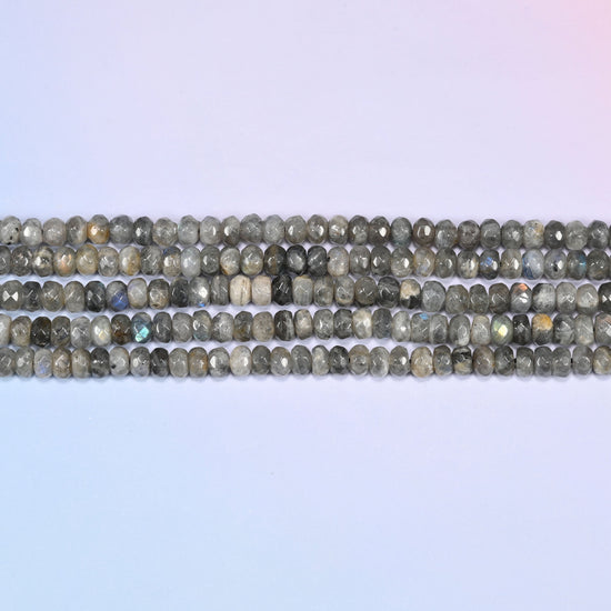 Gray Labradorite faceted rondelle beads in horizontal rows, the flat disc shape sitting close along the strand