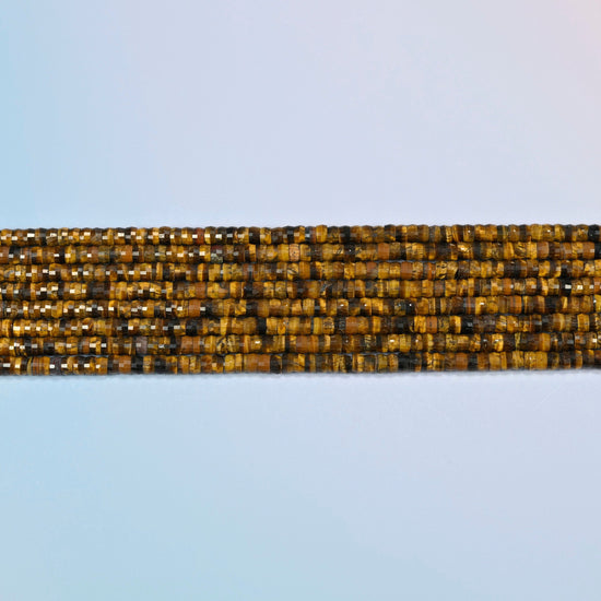 Several strands of tiger eye faceted heishi disc beads laid in straight rows