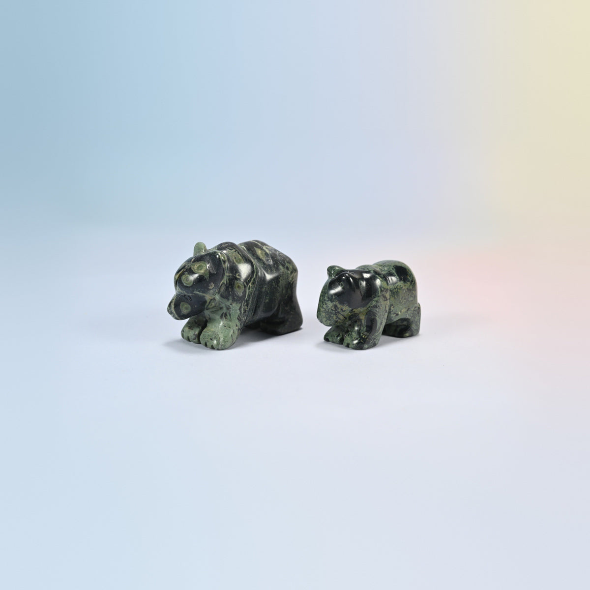 A 2 inch and a 1.5 inch kambaba jasper bear crystal carving, dark green natural stone with black orb patterns