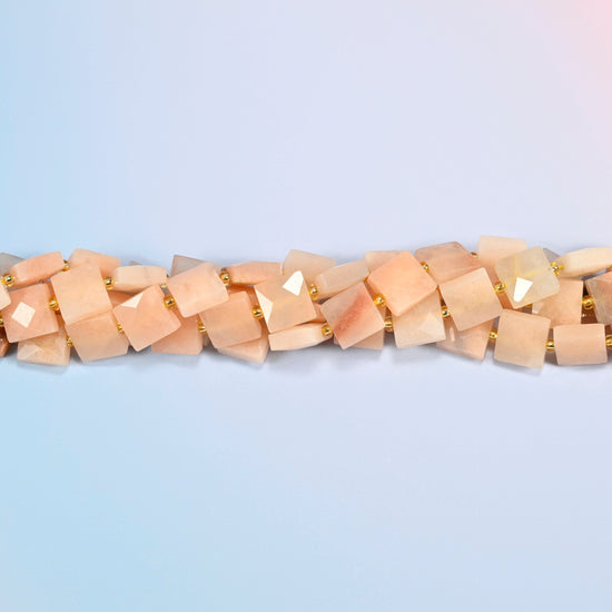 Strands of natural pink aventurine faceted flat square beads twisted together in a horizontal row
