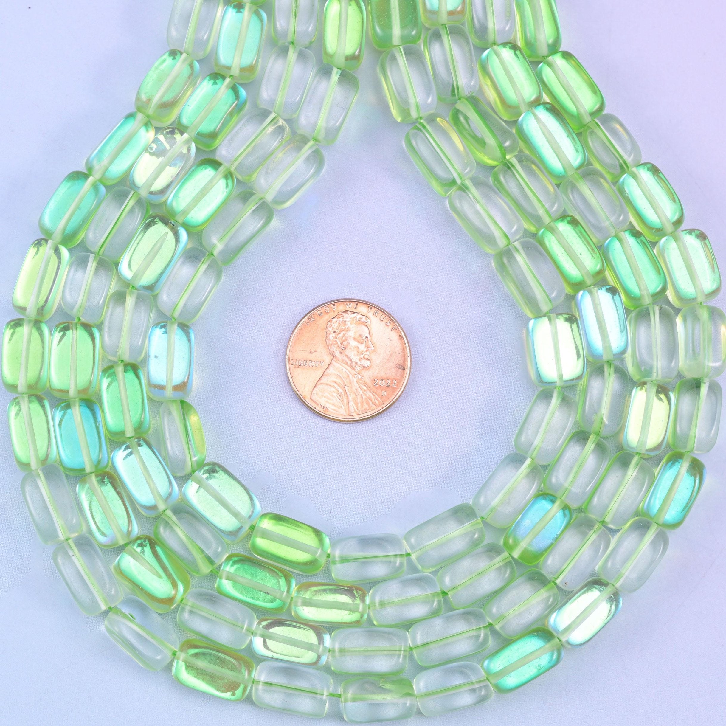 Green Mystic Aura glass beads in a rectangular cut with a glossy transparent finish, featuring a fresh lime-green shine with a subtle iridescent glow