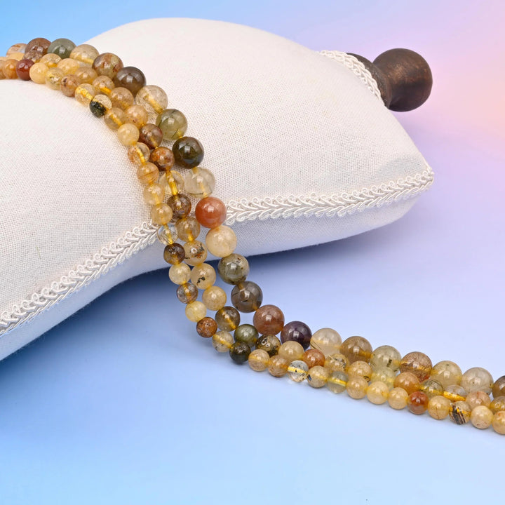 Multi-Color Rutilated Quartz Smooth Round Beads with rusty red and olive rutile needles.