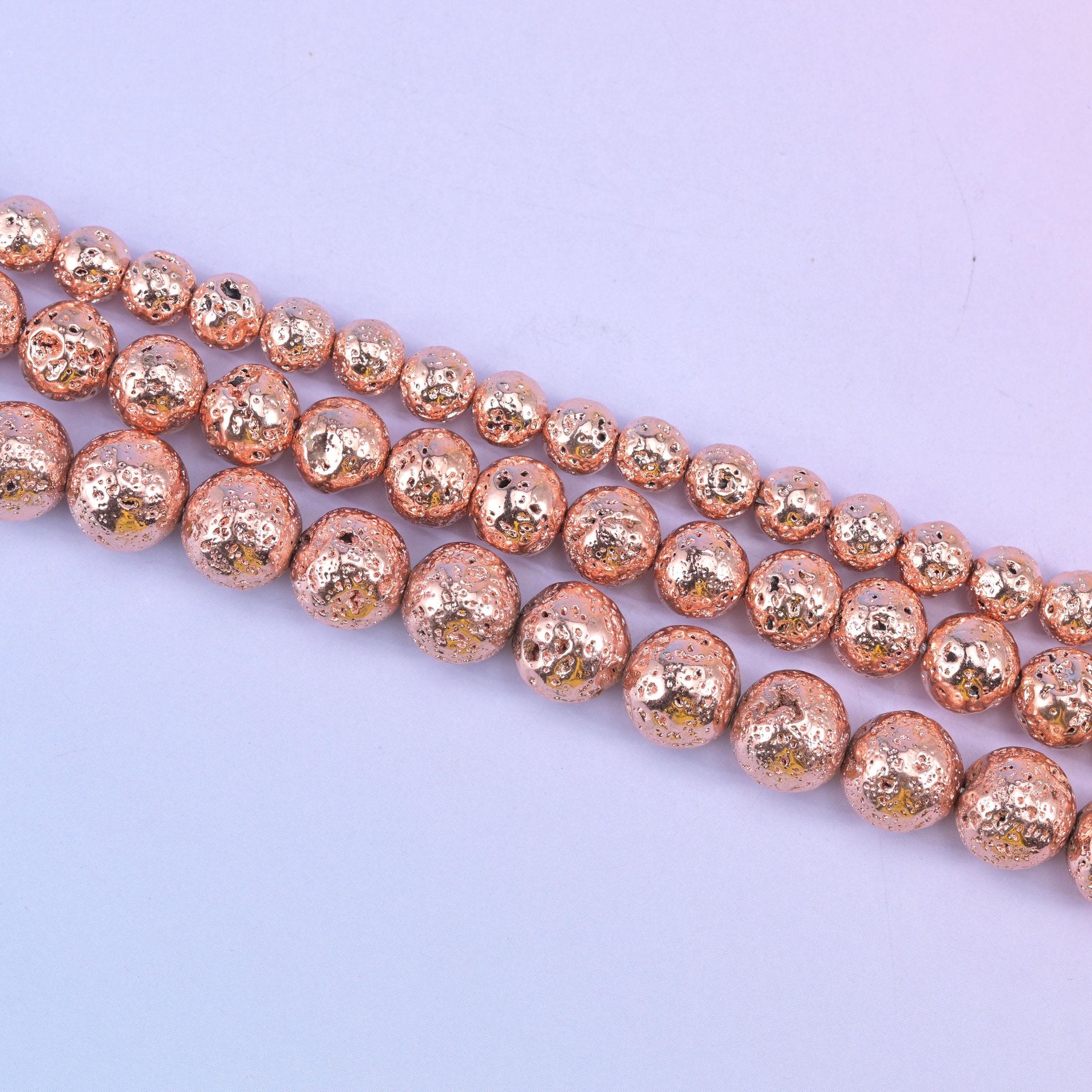 Volcano Rock Lava Beads with a deep pitted, sponge-like surface under the rose gold coating