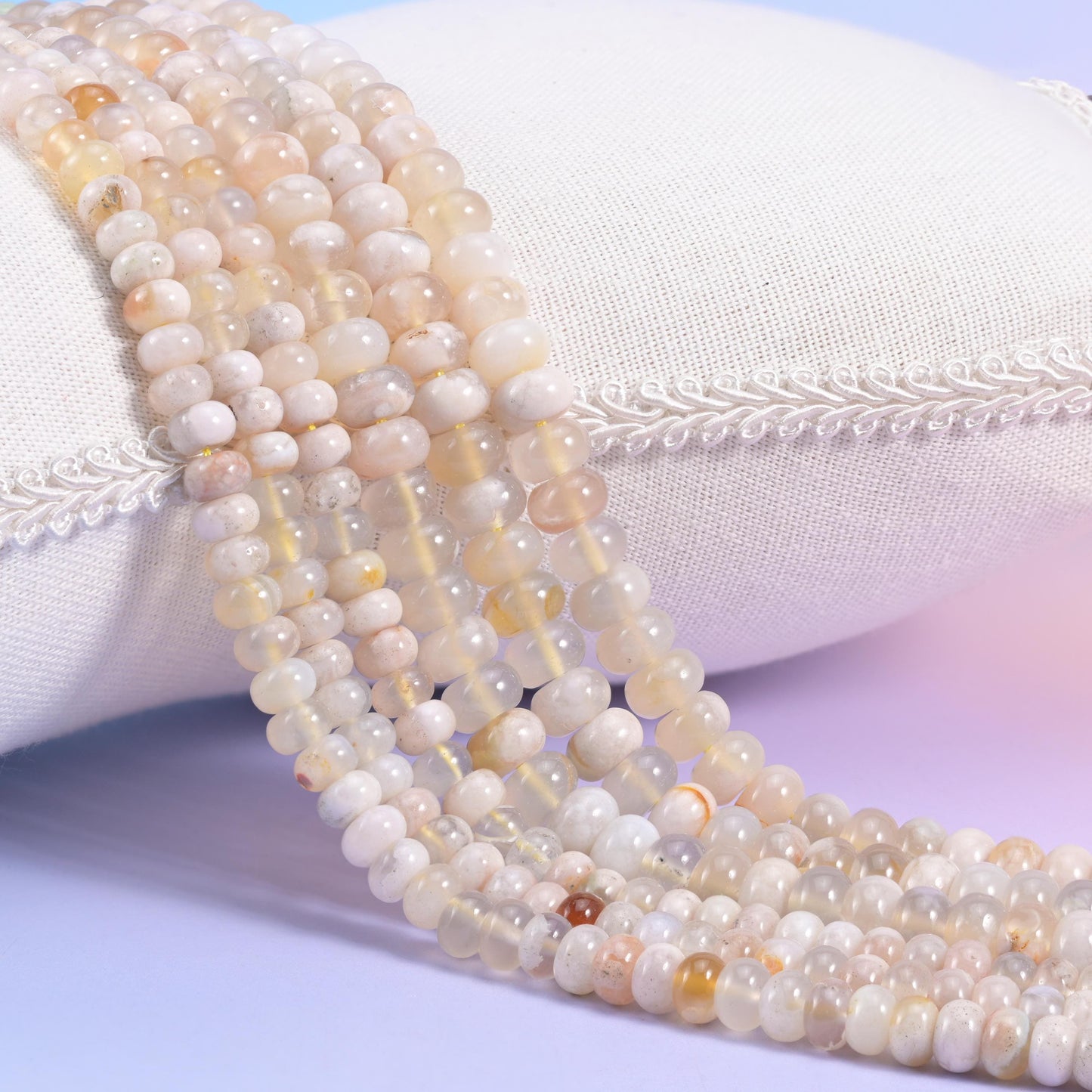 Natural Sakura Agate smooth rondelle beads in soft cream and translucent white with warm golden-peach accents