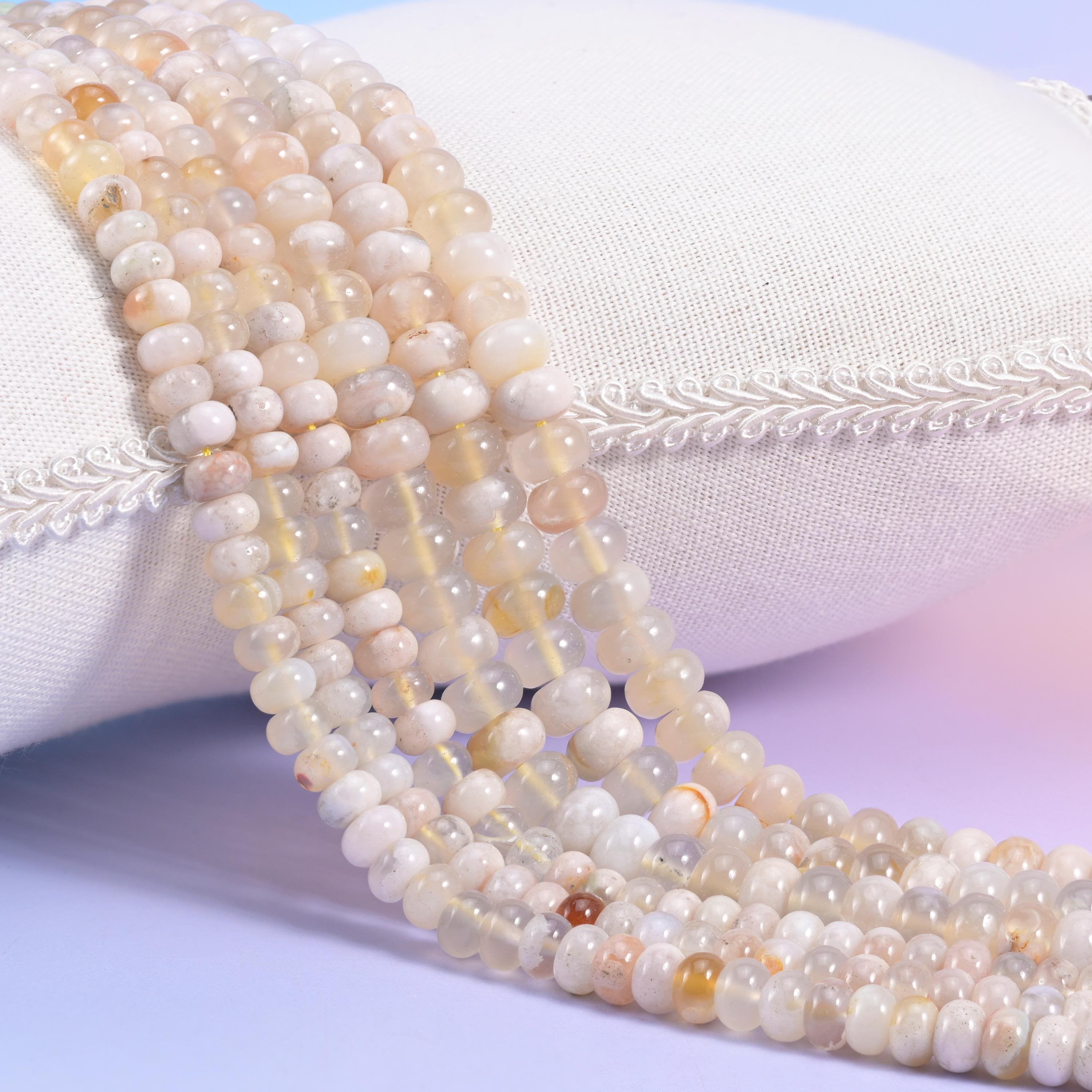 Natural Sakura Agate smooth rondelle beads in soft cream and translucent white with warm golden-peach accents