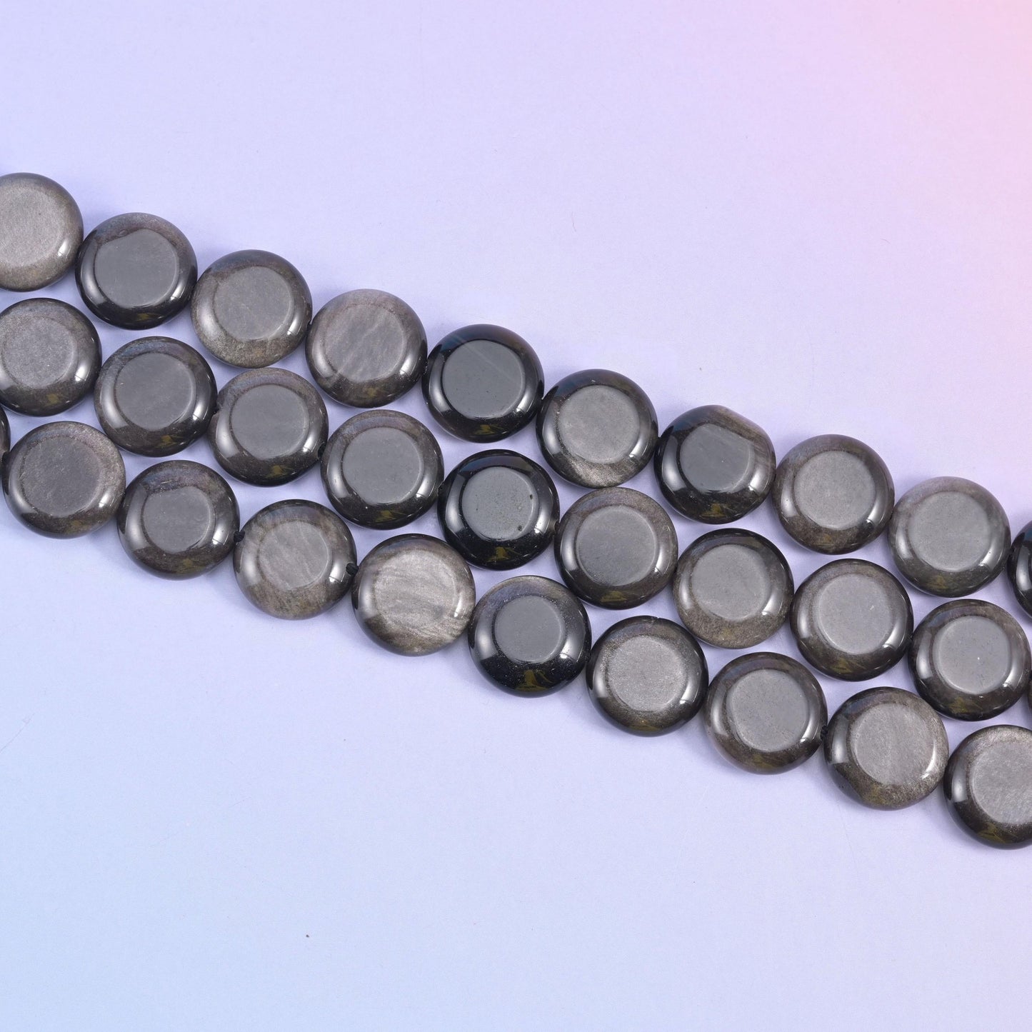 Silver Obsidian coin beads with a shimmering silver sheen across a black mirror finish