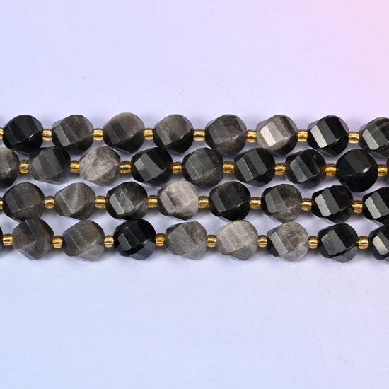 Silver Obsidian natural stone beads with some beads flashing brightly beside others reading as solid charcoal