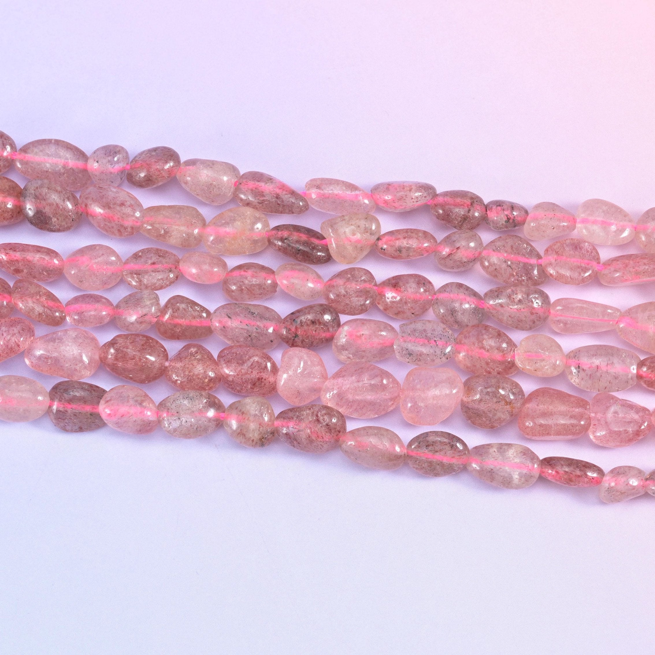 Strawberry Quartz Pebble Nugget Beads in translucent dusty rose with reddish-brown inclusions