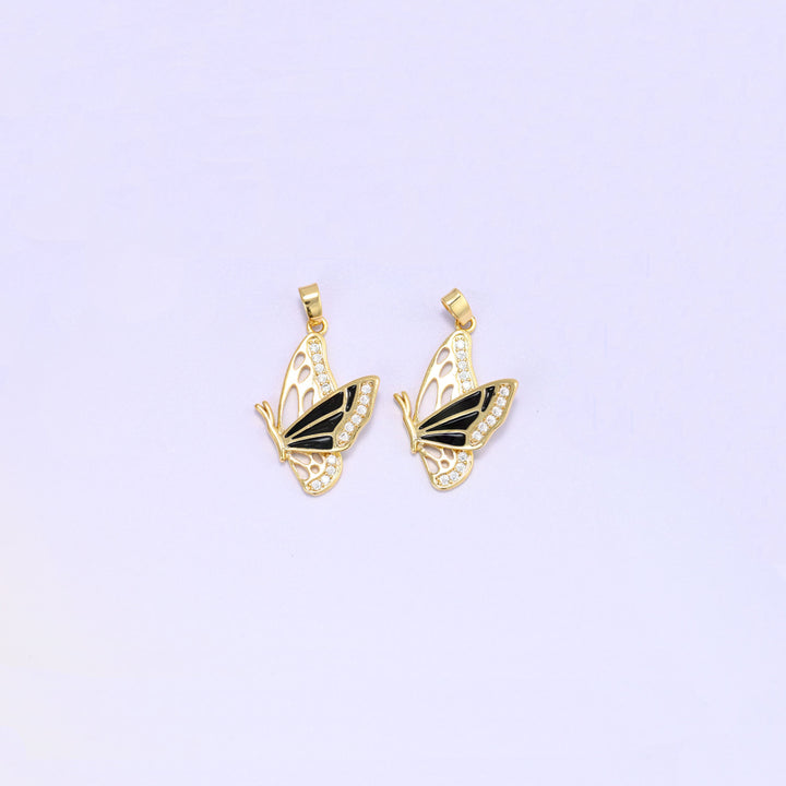Black colourway of the flying butterfly charm pendant, a pair of gold plated charms with black enamel wings and clear zirconia set along the wing edges.