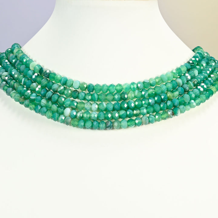 Dyed Green Strip Agate gemstone rondelle beads 4x6mm shown on a white neck display as a layered necklace