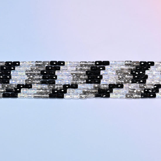 Black gray clear faceted rectangle glass beads in level rows, short rectangles lying end to end.