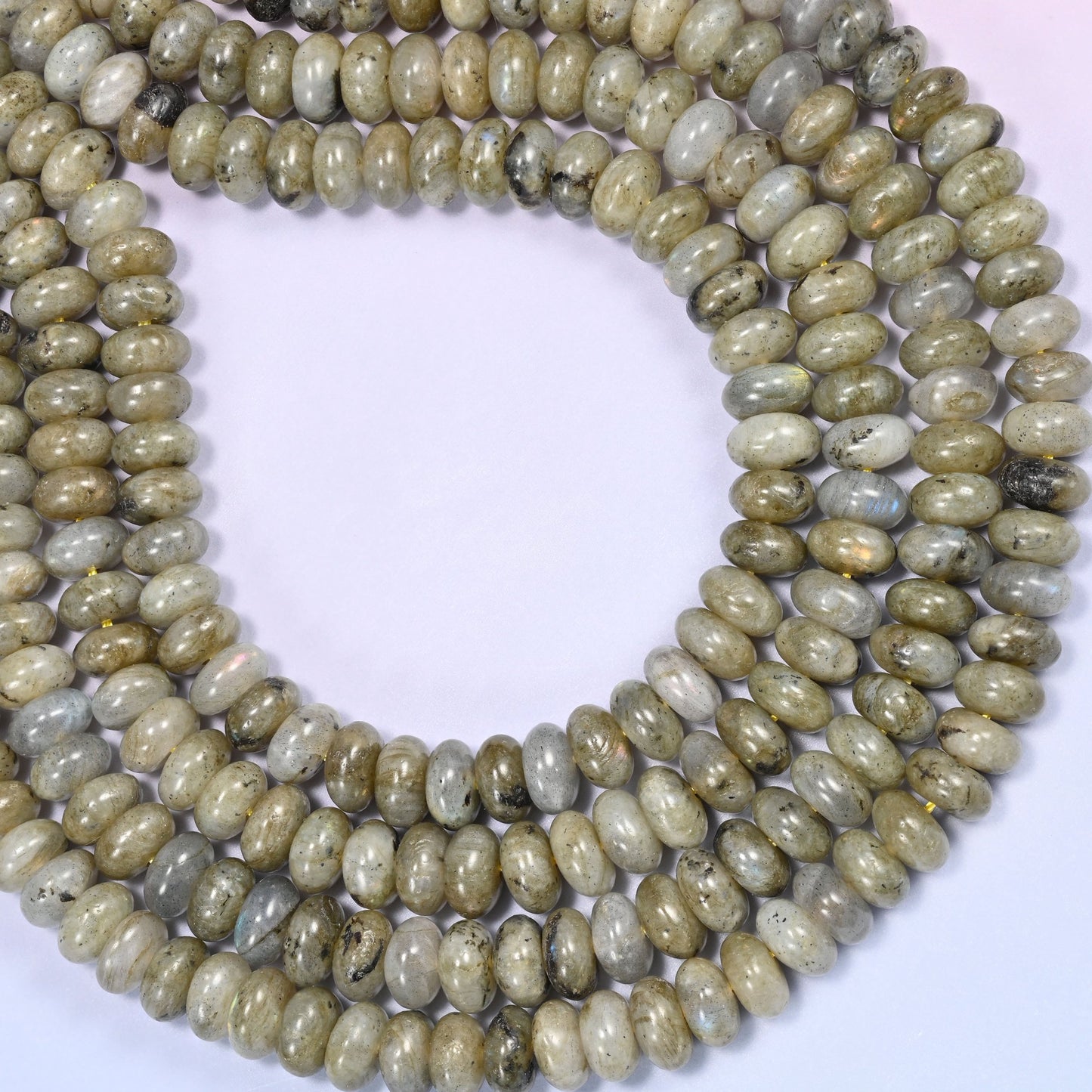 Close-up of coiled Grey Labradorite beads showing the natural iridescent flash.