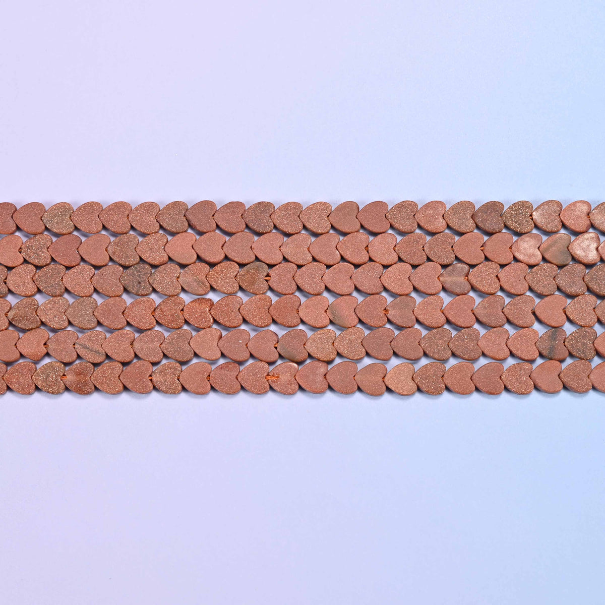 Gold sandstone beads in warm terracotta-brown with a fine sandy matte surface
