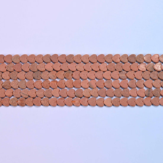 Gold sandstone beads in warm terracotta-brown with a fine sandy matte surface
