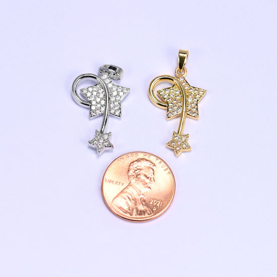 Wishing star zirconia charm scale shot, silver and gold shooting star pendants photographed beside a US penny.