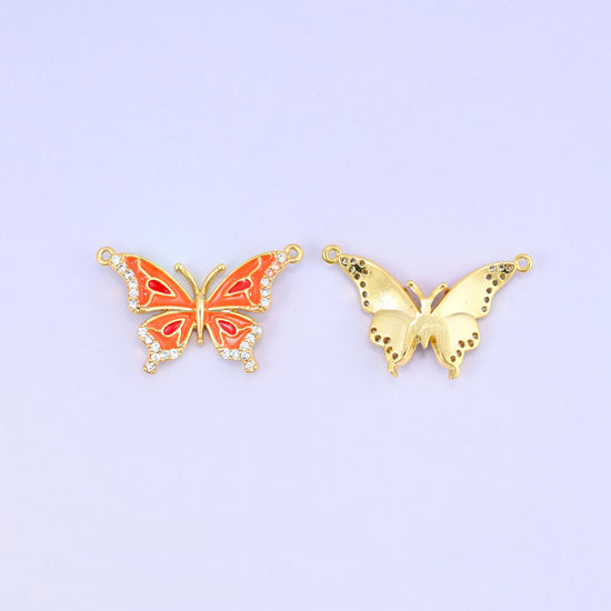 Orange enamel butterfly double connector pendant shown face up next to the plain gold back of a second piece, both with a loop at each upper wing tip.