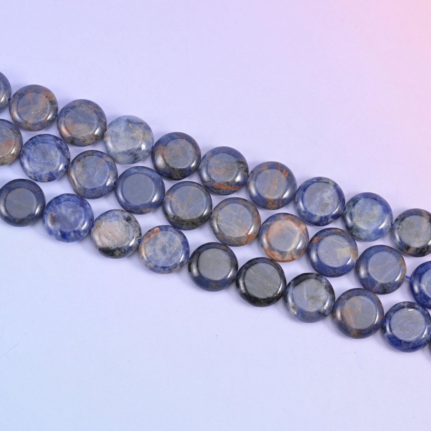 Sodalite coin beads in navy blue with white veining and grey patches