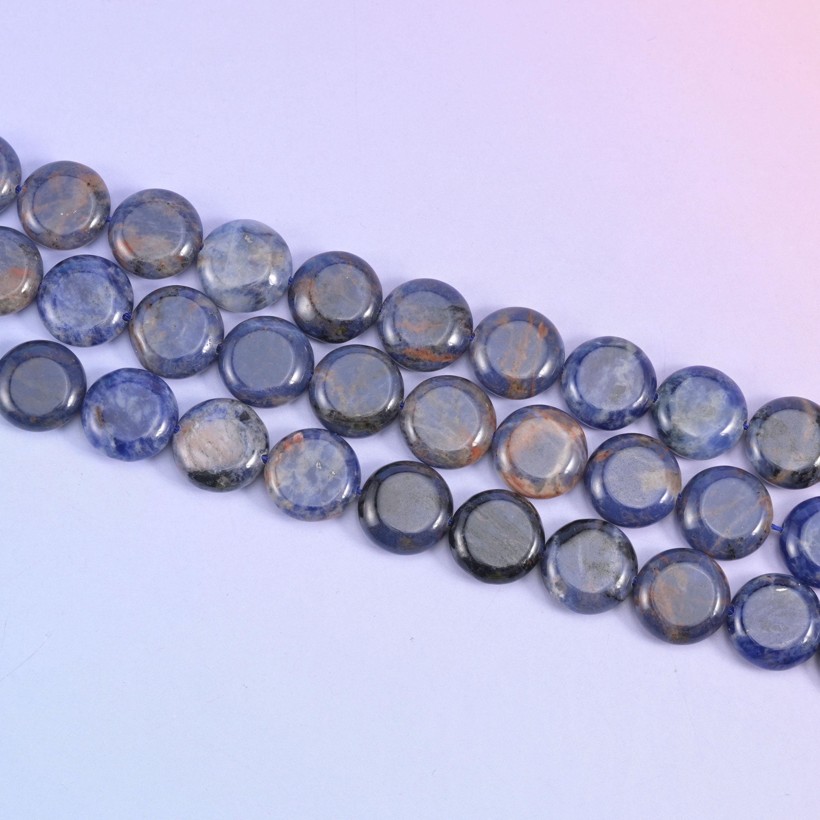 Sodalite coin beads in navy blue with white veining and grey patches