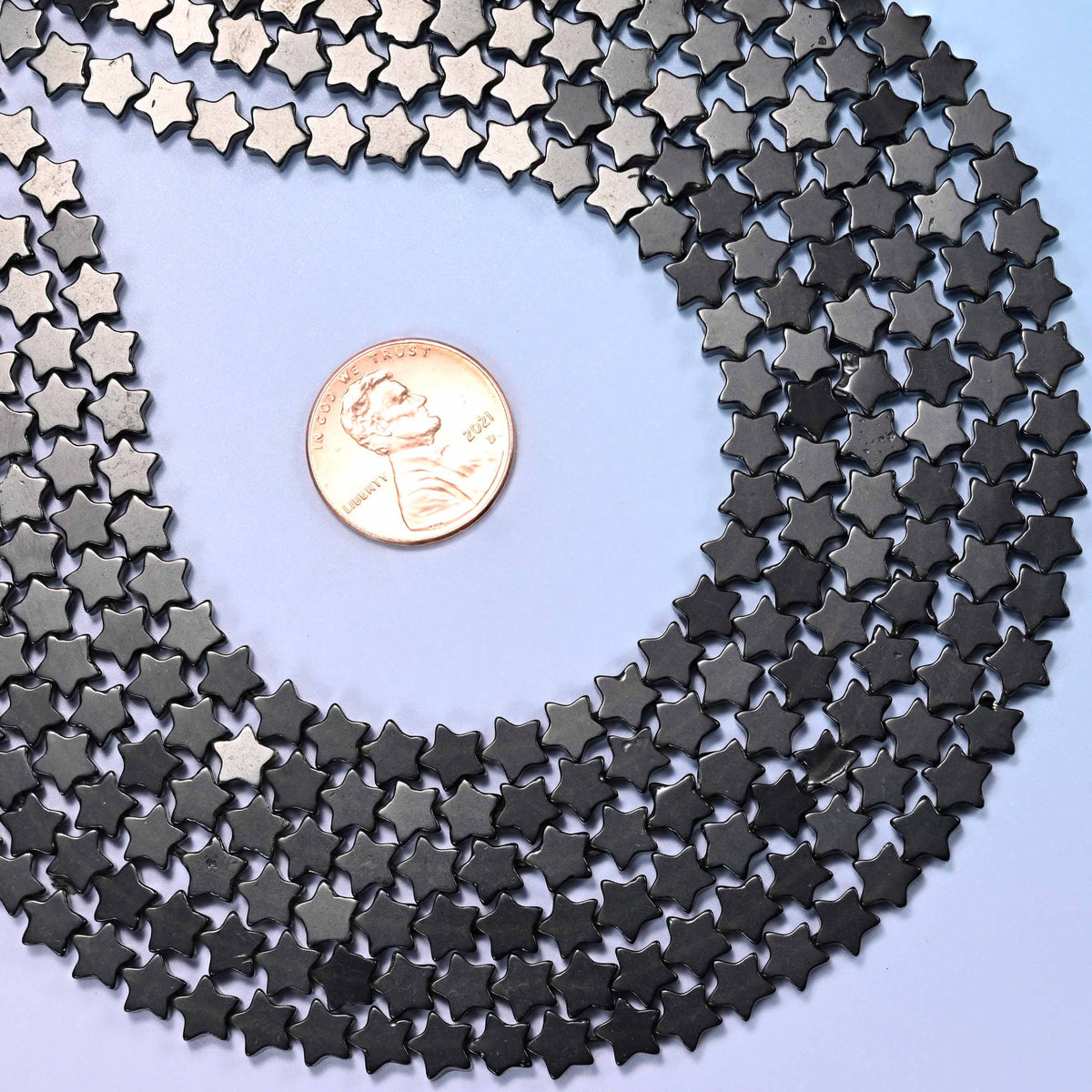 Black Obsidian Flat Star Beads 6mm, approximately 75 beads per strand