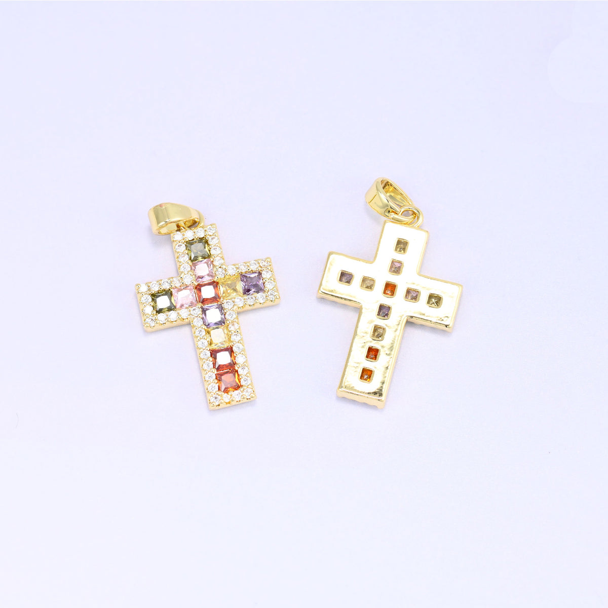 Zirconia cross charm and its reverse, showing the open setting behind each coloured stone