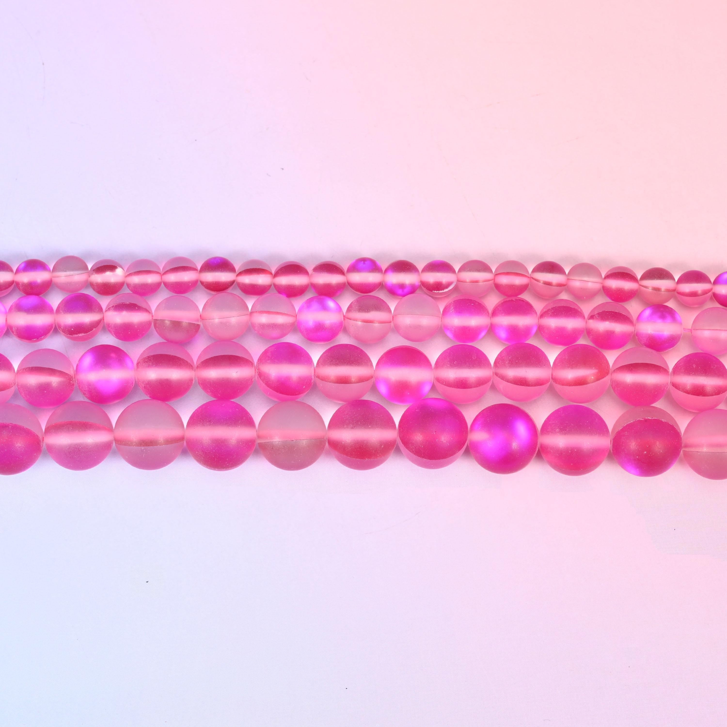 Matte glass beads in frosted raspberry-pink with an iridescent aura core
