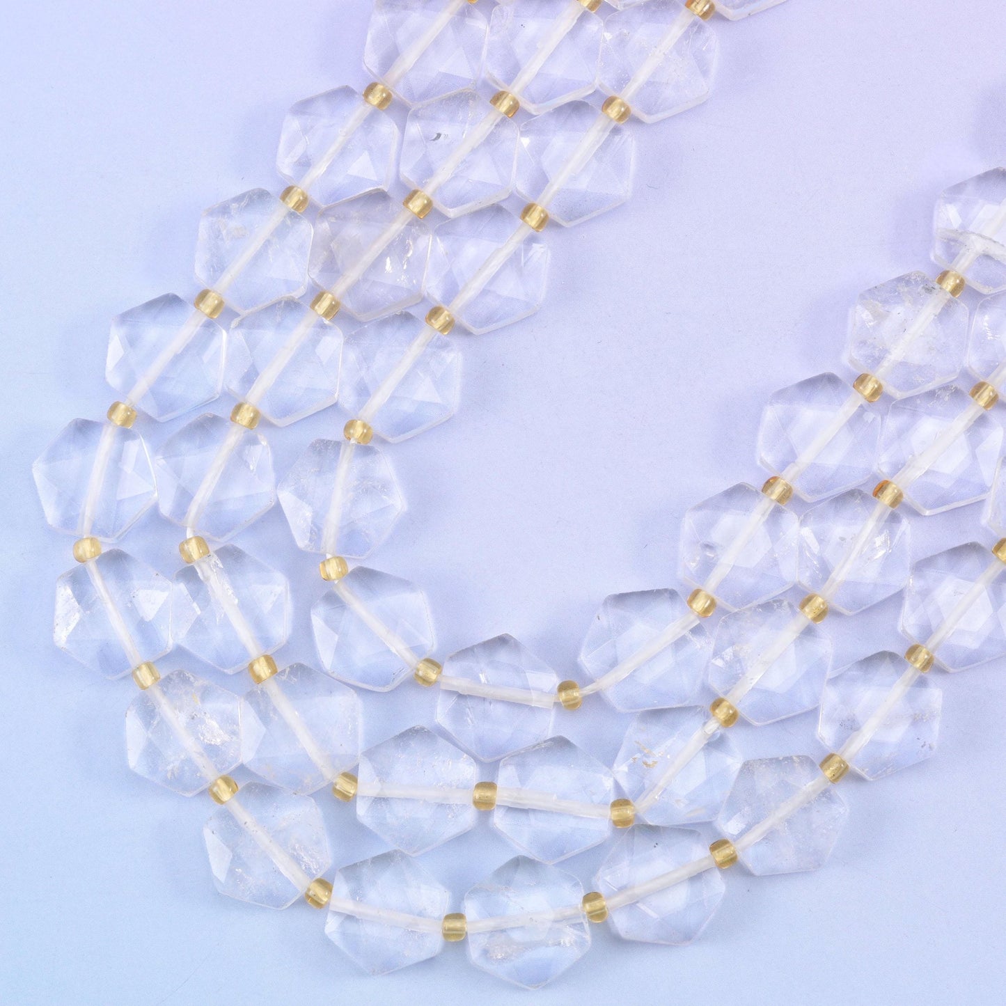 Clear quartz hexagon beads, approximately 27 beads per strand