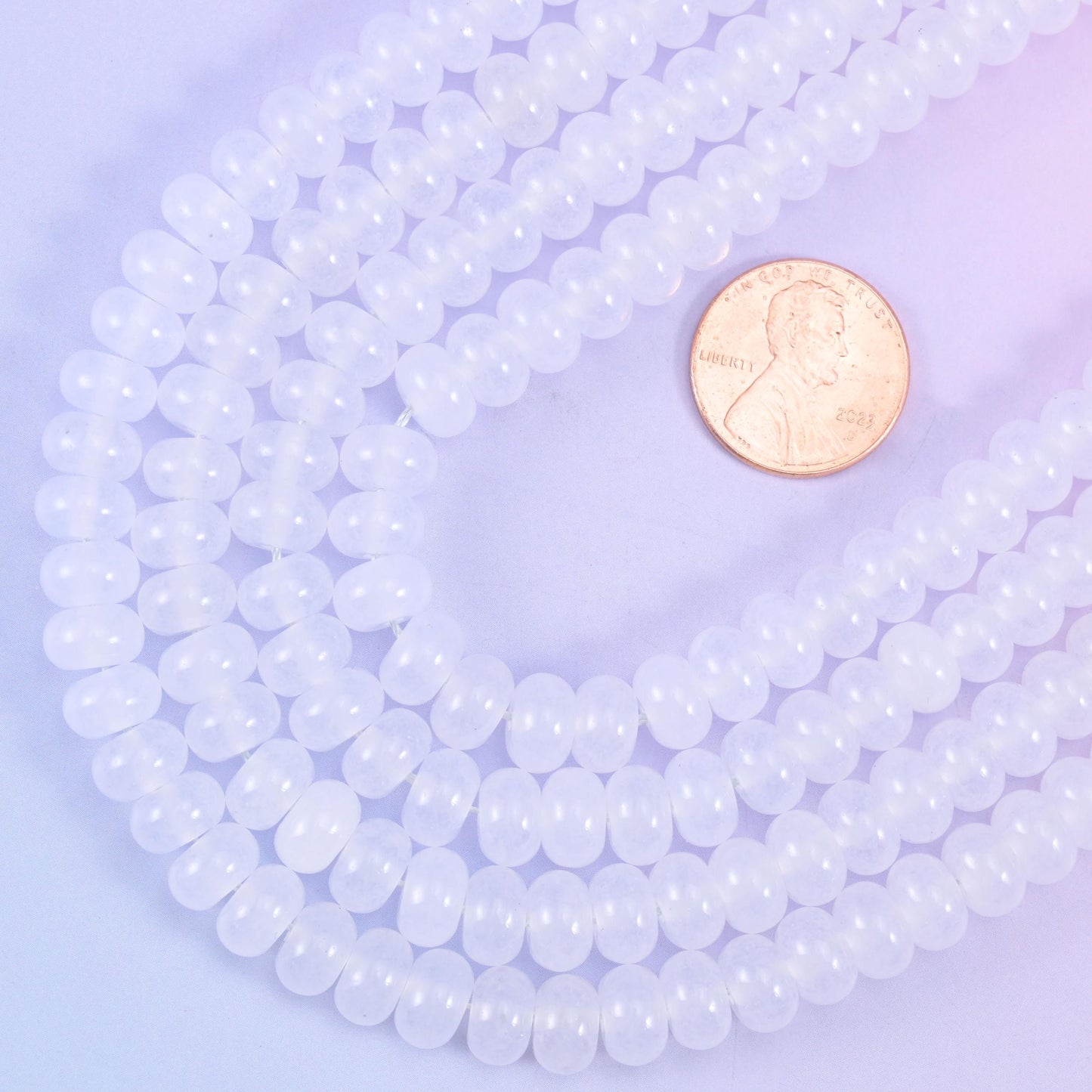 Smooth rondelle cut dyed jade beads with a polished surface
