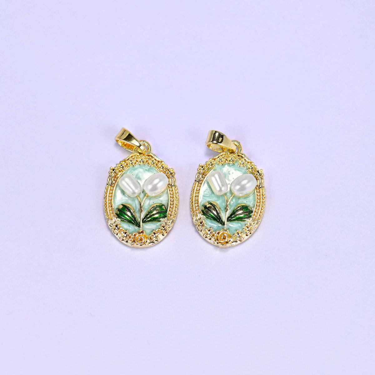 Enamel Oval Tulip Flower Pendants in mint, a matched pair with white faux pearl tulips and green leaves inside an ornate gold oval.