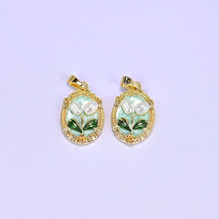 Enamel Oval Tulip Flower Pendants in mint, a matched pair with white faux pearl tulips and green leaves inside an ornate gold oval.