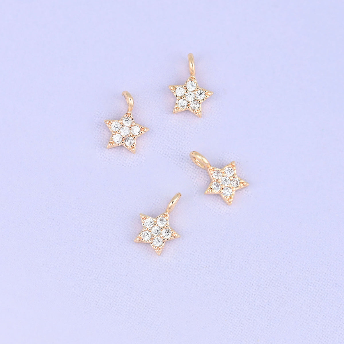 Small gold charms, four gold plated star charms with clear cubic zirconia