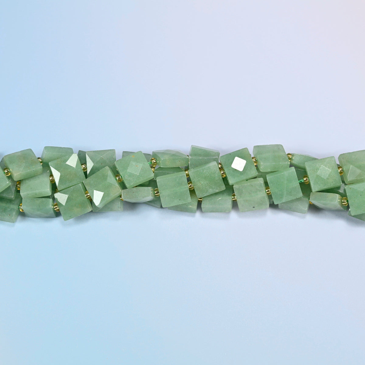 Strands of natural green aventurine faceted flat square beads twisted together in a horizontal row