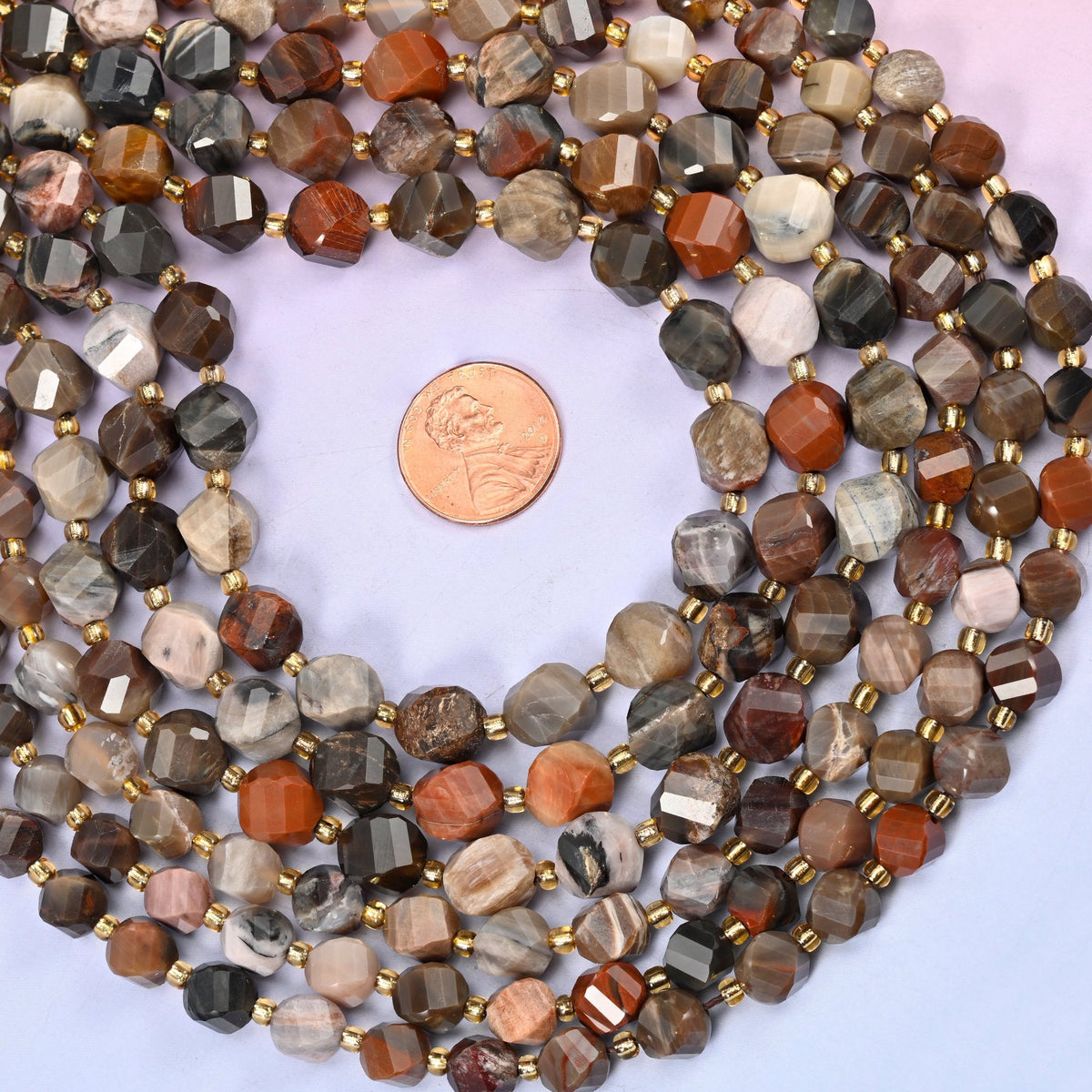 Petrified Wood faceted spiral twist beads showing the striped growth rings of the original timber