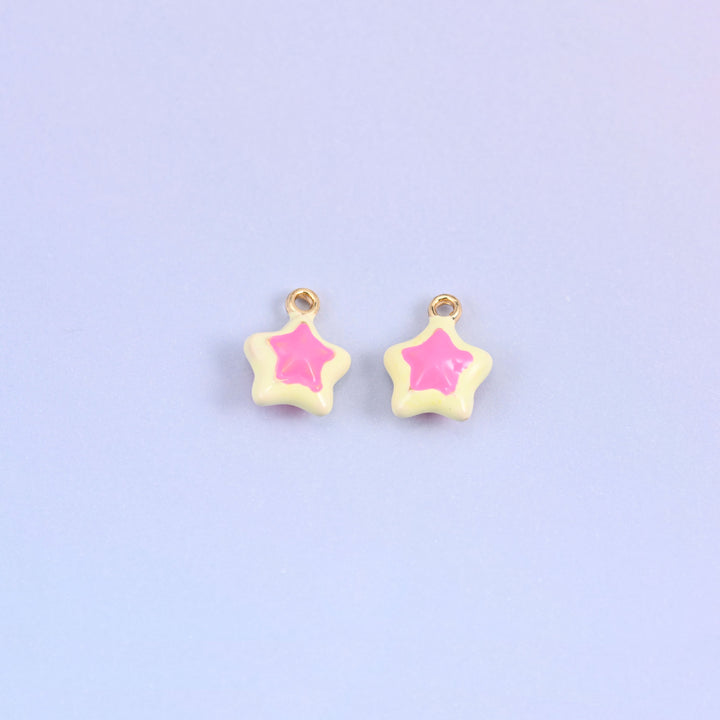 Light yellow star charms with a pink inset star, glossy enamel over 18K gold plated brass, 14 x 11mm.