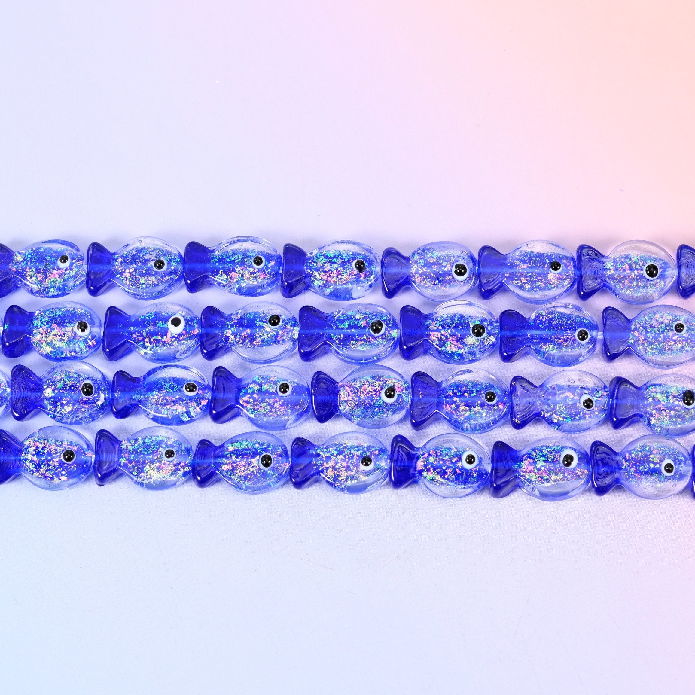 Iridescent Dark Blue Fish Glass Beads in cobalt blue with a silvery glitter core