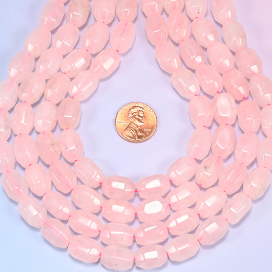 Close-up circular coil of Rose Quartz faceted barrel beads, showing the dense blush pink pattern.