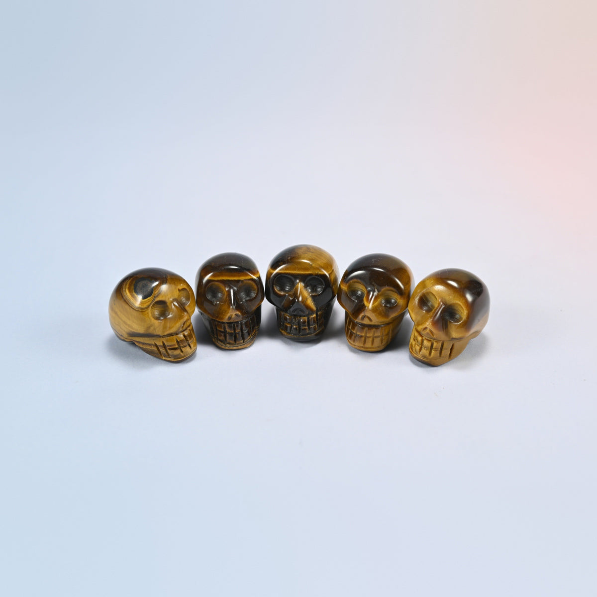 1 inch skull crystal carving in tiger eye, golden brown natural stone with shimmering bands