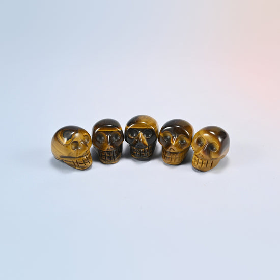 1 inch skull crystal carving in tiger eye, golden brown natural stone with shimmering bands