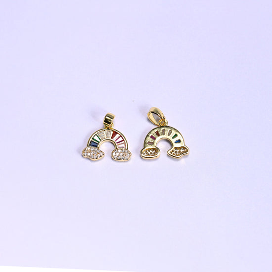 Front and back of the gold Rainbow Zirconia Charm, the multicolor zirconia arc on the left and the plain gold reverse on the right.