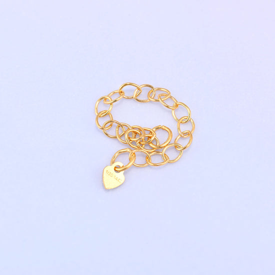 14K gold filled heart chain extender coiled into a loop, close-up showing the 1/20 14K stamp on the heart charm.