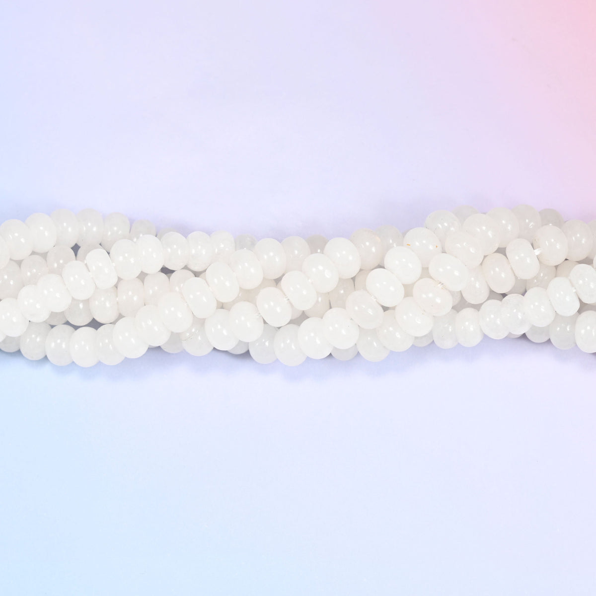 Natural White Jade rondelle beads in a smooth, milky white tone with a soft translucent glow.