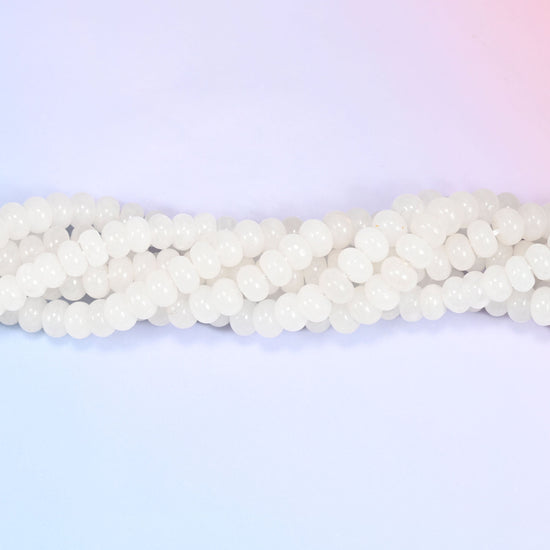 Natural White Jade rondelle beads in a smooth, milky white tone with a soft translucent glow.