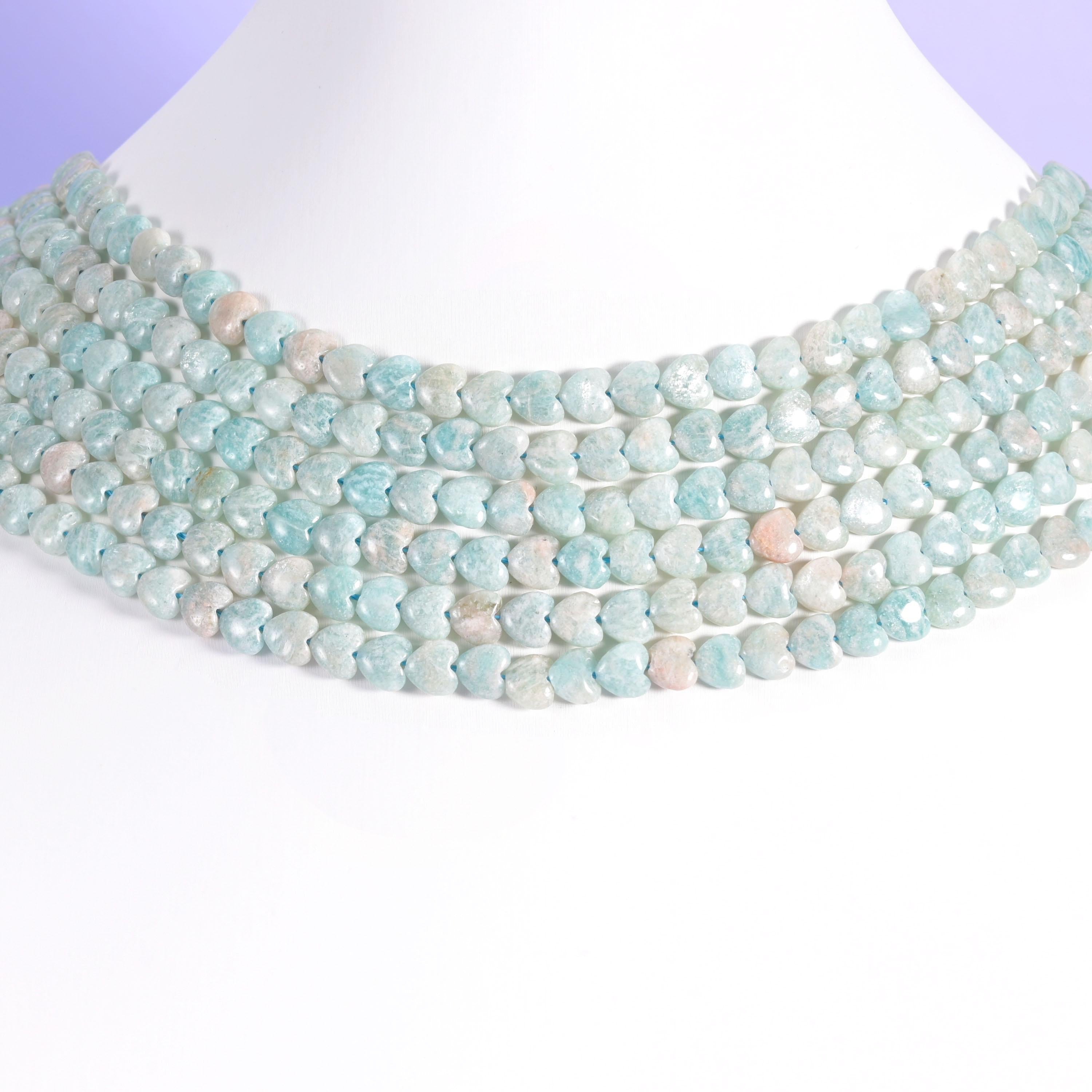 Blue Amazonite heart beads layered in rows on a white neck display form