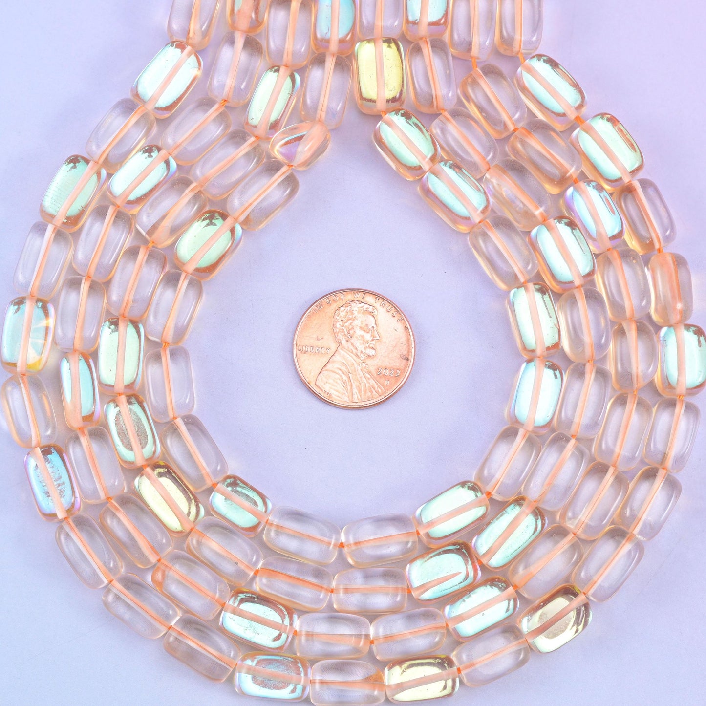 Orange Mystic Aura glass beads in a rectangular cut with a glossy transparent finish, featuring a warm amber-orange shine with a subtle iridescent glow